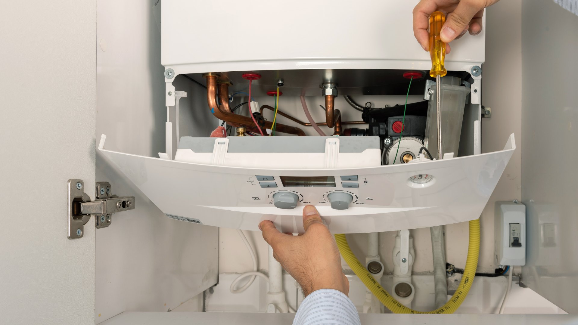 Flow Plumbing & Heating engineer working on a boiler in Stockport