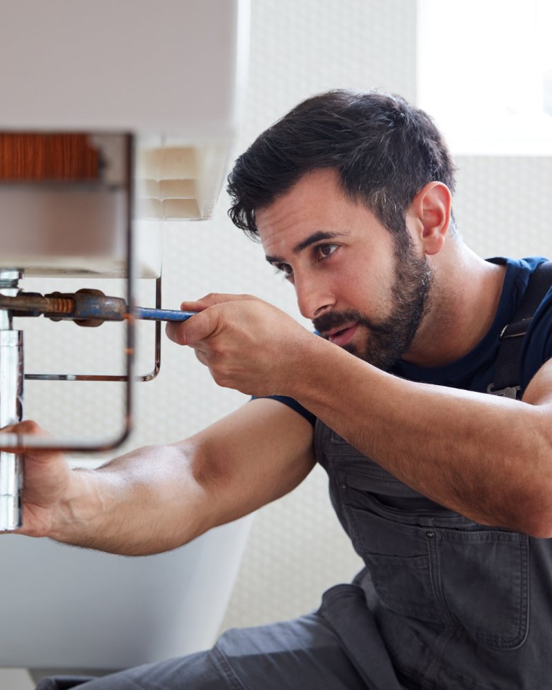 Flow Plumbing & Heating engineer at work in a Trafford property