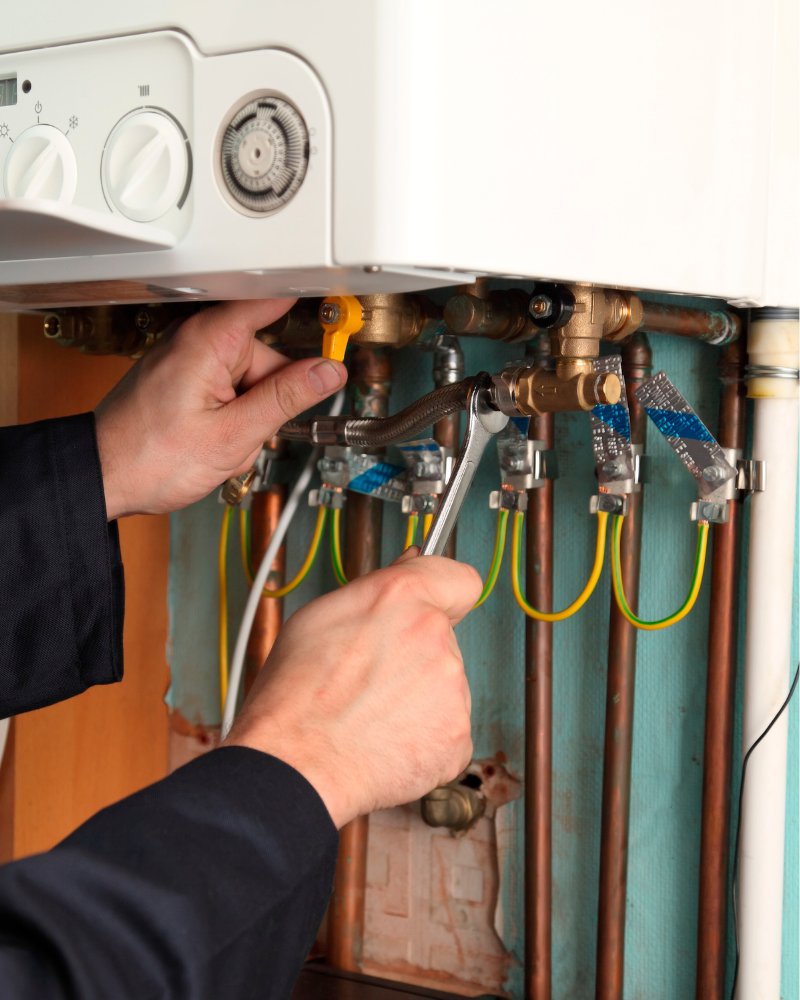 Gas Safe engineer inspecting boiler pipework